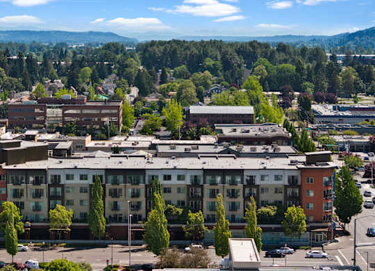 A large building with a parking lot in front of it.