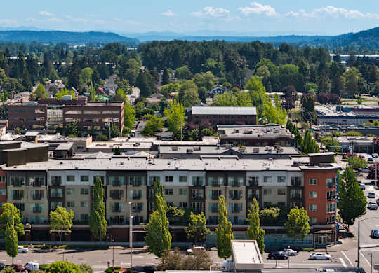 A large building with a parking lot in front of it.