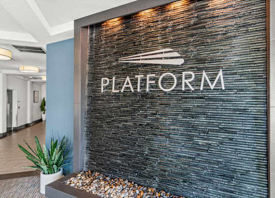 A sign that says Platform is on a wall.