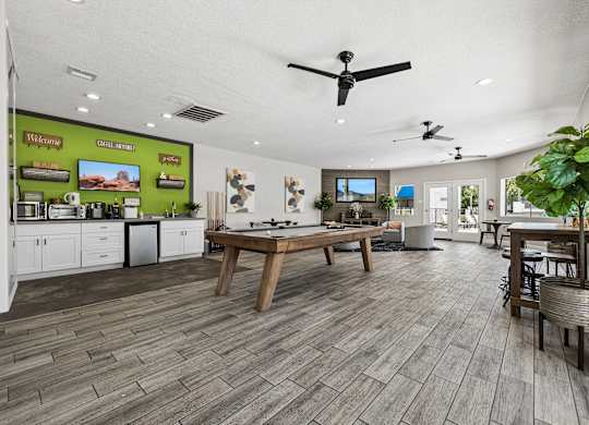 A spacious kitchen and dining area with wooden flooring and modern appliances.