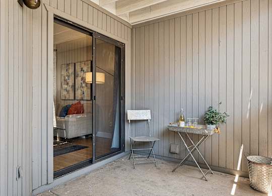 A patio with a table and chairs is shown.