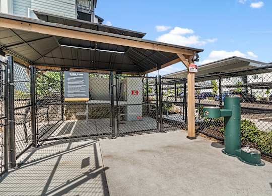 A green post stands in a concrete courtyard.