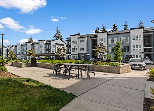 A row of modern townhouses with a clear blue sky above.