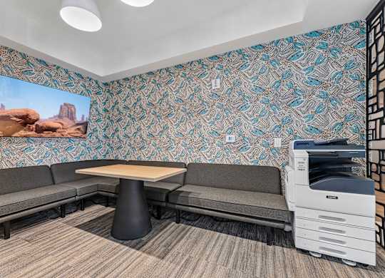 A room with a patterned wallpaper and a desert scene on the wall.