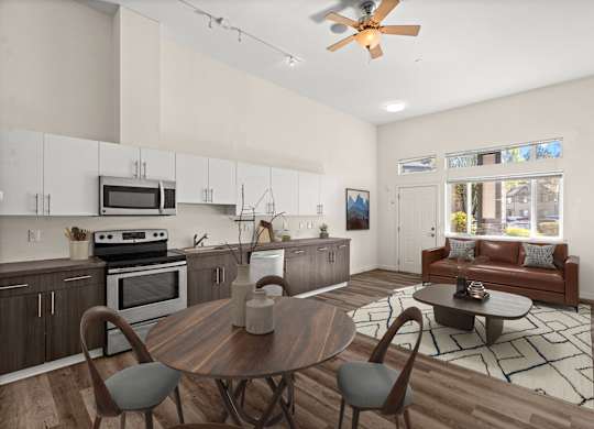 A modern kitchen with a wooden table and chairs.