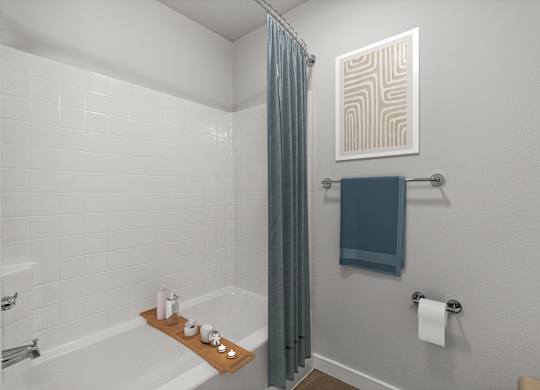 A bathroom with a white tiled shower and a blue towel hanging on the rack.
