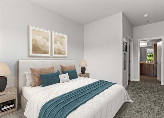 A bedroom with a large bed and two framed pictures on the wall.