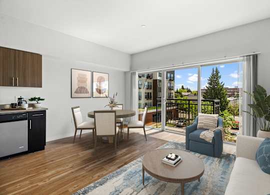 A modern living room with a dining area and a kitchen in the background.