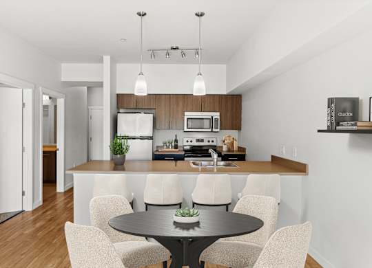A modern kitchen with a dining table and chairs.