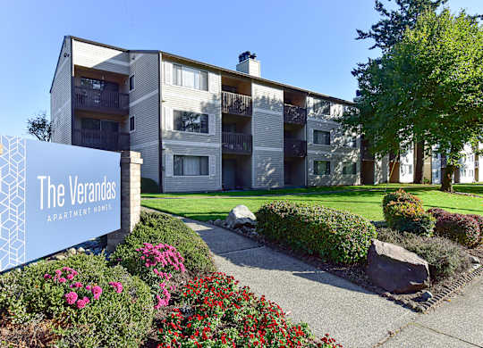 The Verandas Apartment Homes building with a blue sign in front of it.