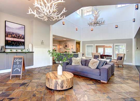 Clubhouse interior with couchat Deer Creek Apartments, Puyallup, WA, 98373