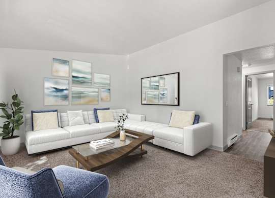 A living room with a white couch, a blue chair, and a painting on the wall.