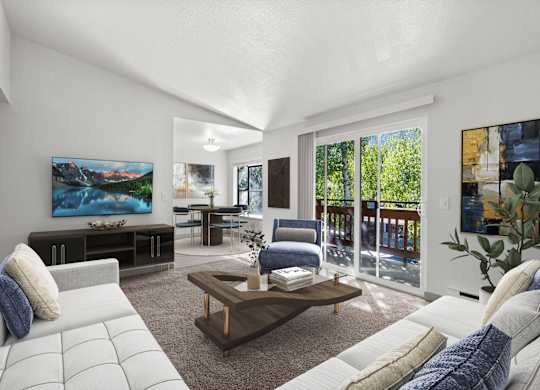 A modern living room with a large painting on the wall and a view of the outdoors through the sliding glass doors.