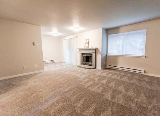Puyallup Apartments - Cambridge on Seventh Apartments - Living Room, Fireplace, and Dining Room at Cambridge on Seventh, Puyallup, WA, 98372