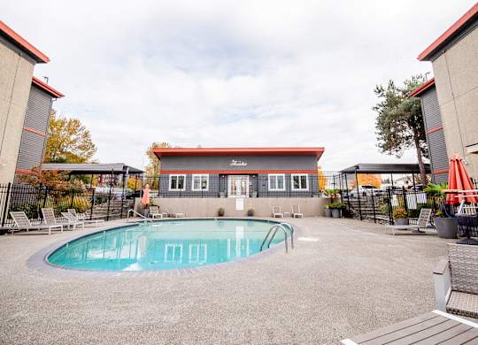 A small pool in a courtyard surrounded by buildings. at The Aviator, Washington, 98055