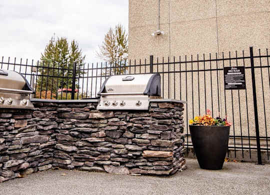 Two grills are mounted on a stone wall. at The Aviator, Washington