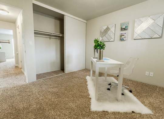 A room with a white desk and a white chair. at The Aviator, Renton, 98055