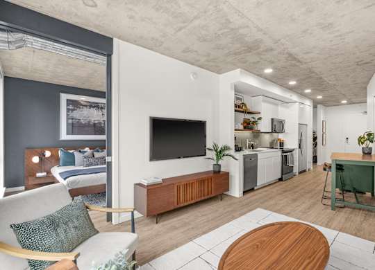 A modern living room with a white couch and a wooden coffee table.