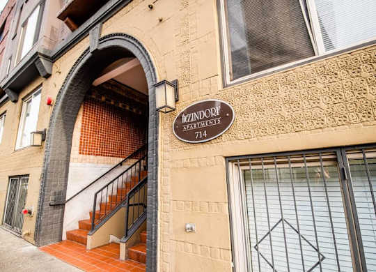 A building with a sign that says  at Zindorf, Seattle, 98104