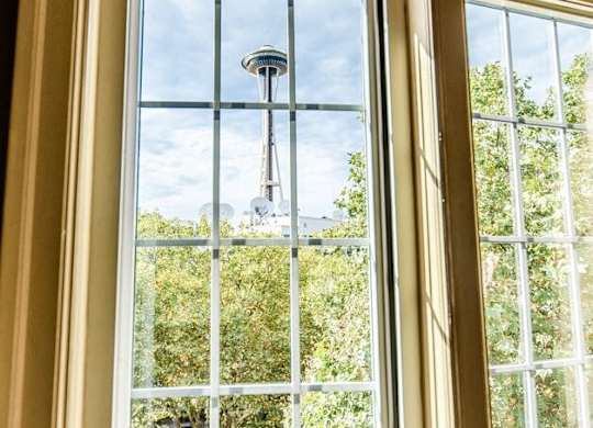 A window with a view of a balcony and trees. at Edwards on Fifth, Seattle, 98121