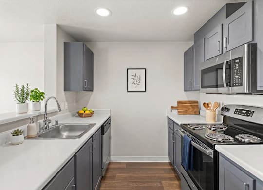 A modern kitchen with a stainless steel oven and microwave.