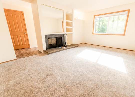 A room with a fireplace and a window. at The Retreat, Sumner, WA, 98390