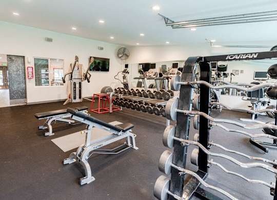 A gym with a variety of equipment including a squat rack and a bench press. at Notch 8, Tacoma, WA, 98444