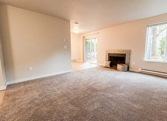 A room with a fireplace and a carpet on the floor. at Notch 8, Washington, 98444