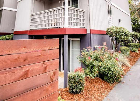 A grey building with a red fence in front. at Notch 8, Tacoma