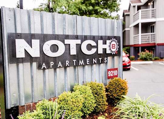 A sign for Notch Apartments is in front of a building. at Notch 8, Tacoma, Washington