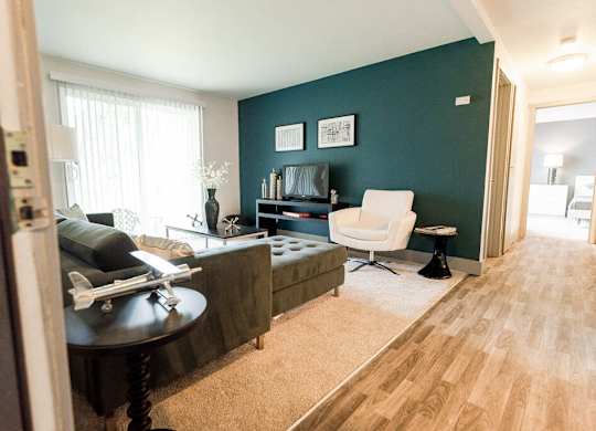 A living room with a couch, chair, and a table.
