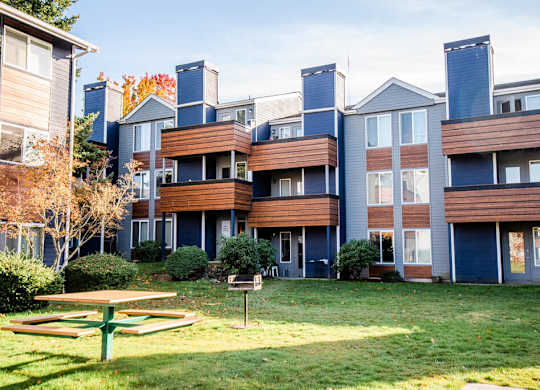 A large apartment complex with a picnic table in front. at Northpoint Apartments, Tacoma, 98407