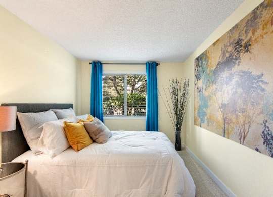 A bedroom with a large bed and a painting on the wall. at The Retreat, Sumner, WA, 98390