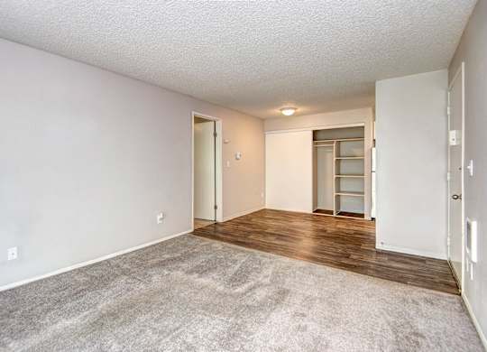 A room with a carpeted floor and a door leading to another room. at The Lakes at Fife, Fife, WA, 98424