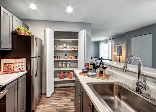 Kitchen with appliances at Deer Creek Apartments, Puyallup