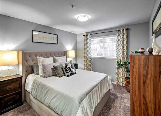Bedroom with bed and lamp at Deer Creek Apartments, Puyallup, 98373