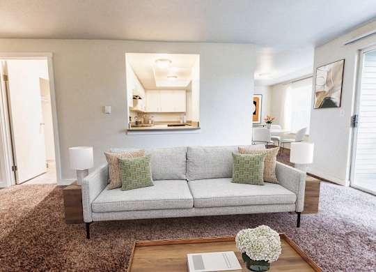 A living room with a grey couch and a coffee table.