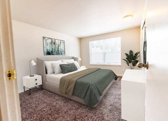 A bedroom with a bed, nightstand, and lamp.