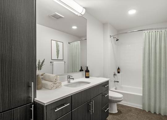A bathroom with a sink, toilet, and bathtub.