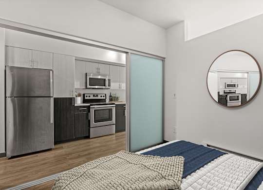 A modern kitchen with a refrigerator, oven, and microwave.