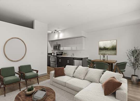A living room with a white couch and green chairs.