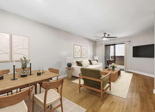 A living room with a wooden table and chairs.
