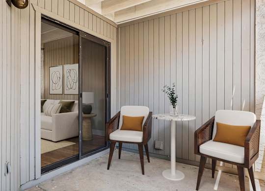A patio with a table and two chairs.