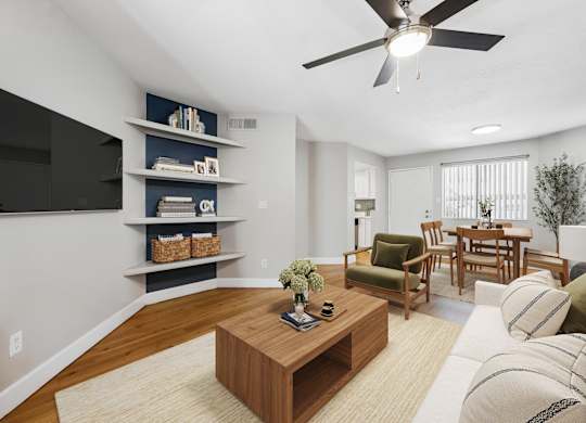 A living room with a wooden coffee table and a flat screen TV mounted on the wall.