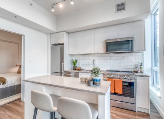 Fitted Kitchen With Island Dining at BLVD Beltline, Calgary, AB