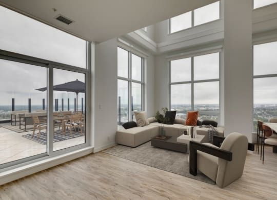 a living room with large windows and a couch and a table at BLVD Beltline, Calgary, AB