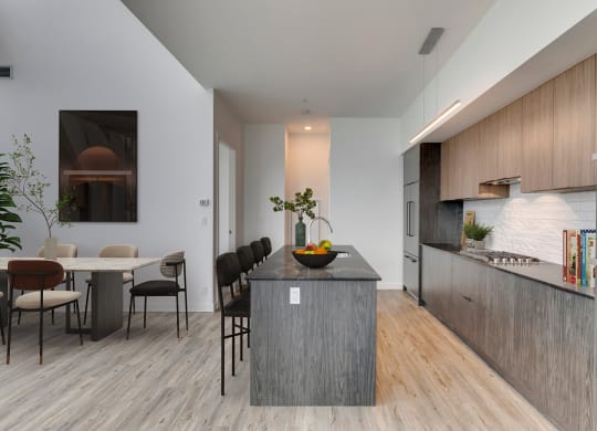a kitchen with a large island and a dining table at BLVD Beltline, Calgary, AB