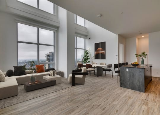 a living room with a large window and a table with chairs at BLVD Beltline, Calgary, AB