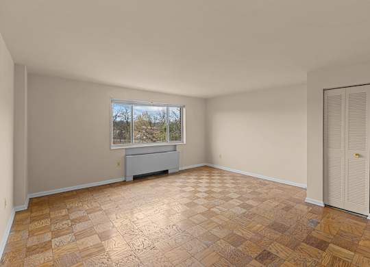 A room with a brown tiled floor and a window at Kensington House, Kensington, Maryland