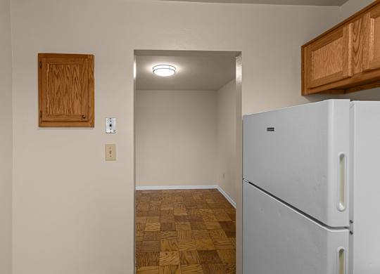 A kitchen with a white fridge at Kensington House, Kensington
